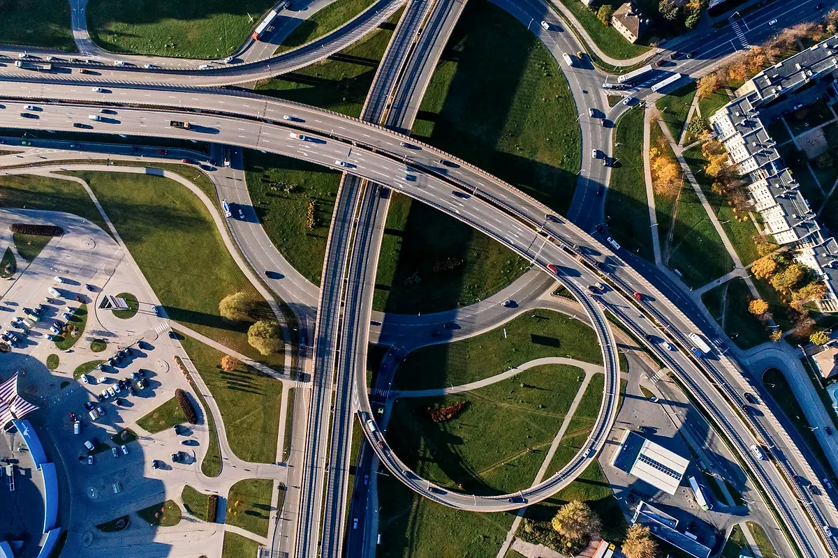 Aerial view of a highway interchange with curving ramps.