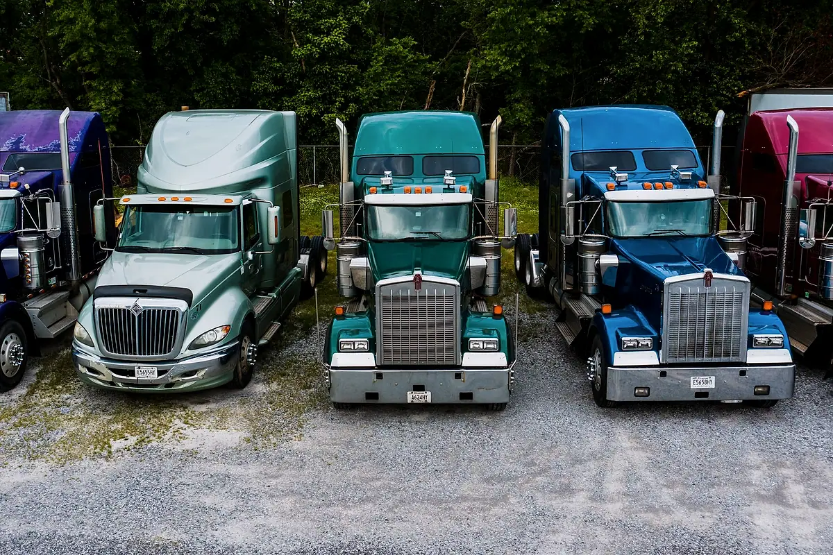 A row of tractor units parked on a gravel lot in Chattanooga, Tennessee.